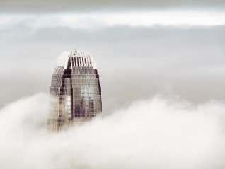 Skyscrapper building peaking through the clouds
