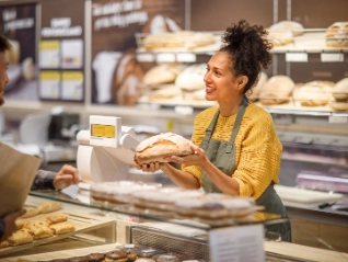 Woman selling bread at a bakery