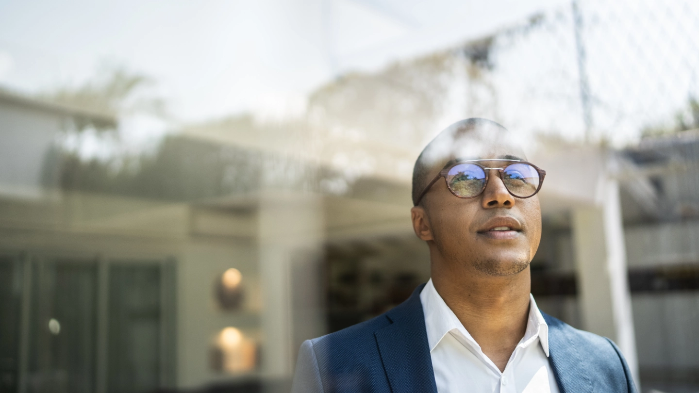 man looking out of window