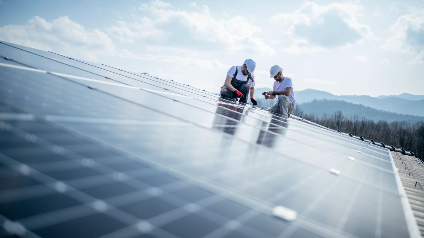Two engineers installing solar panels