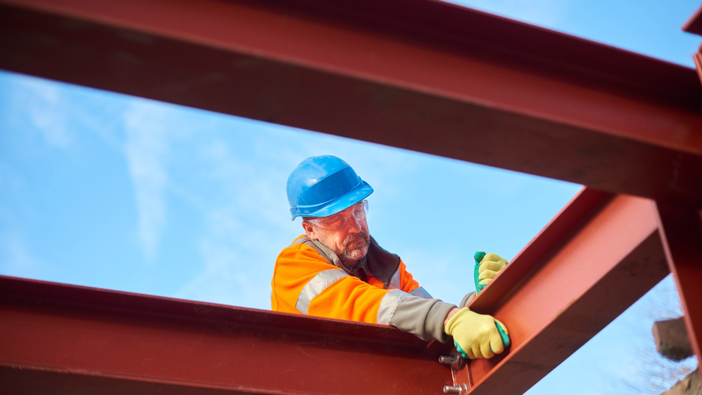 construction worker erecting girders