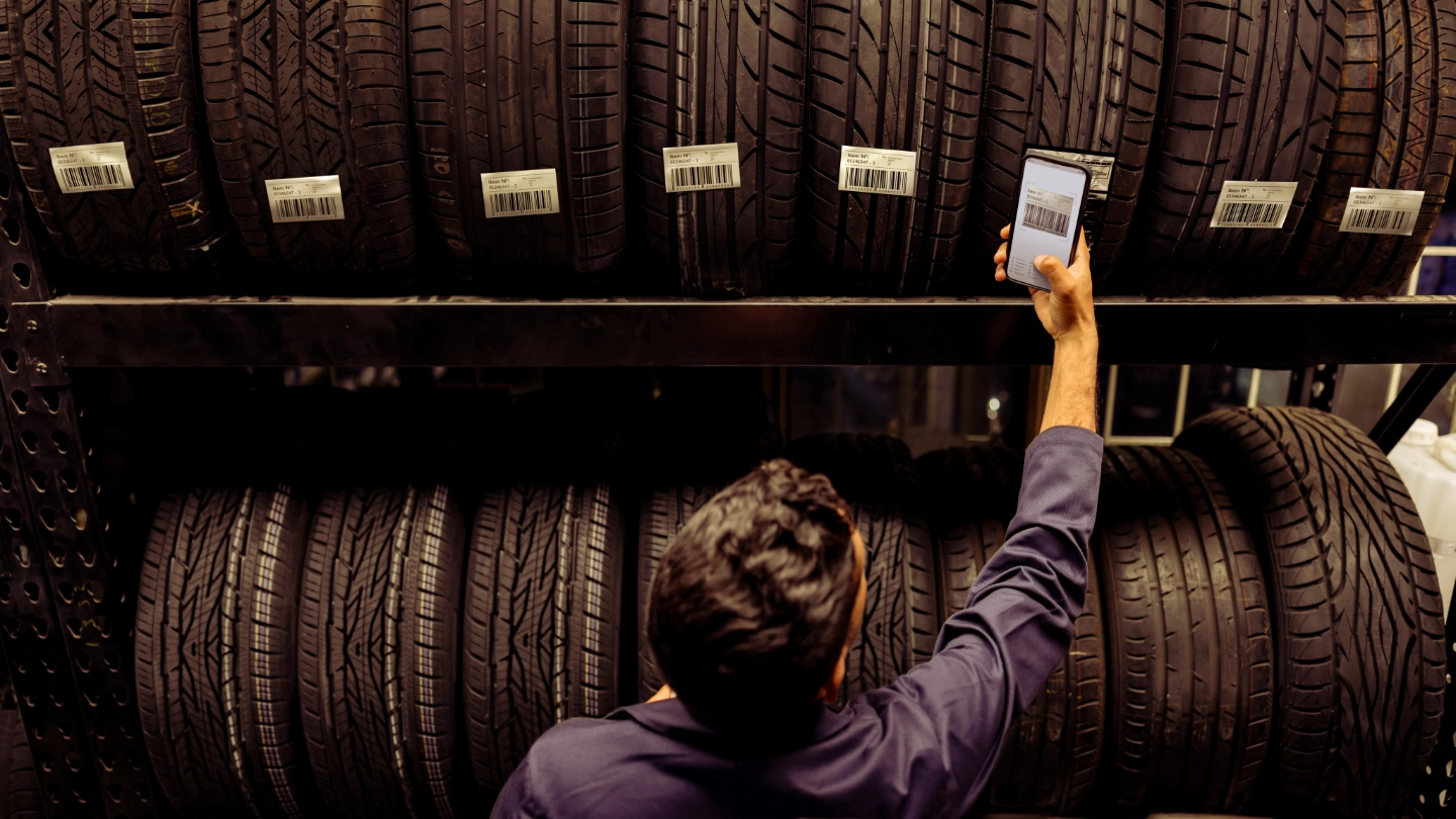 Automotive worker checking tyres Automotive worker checking tyres