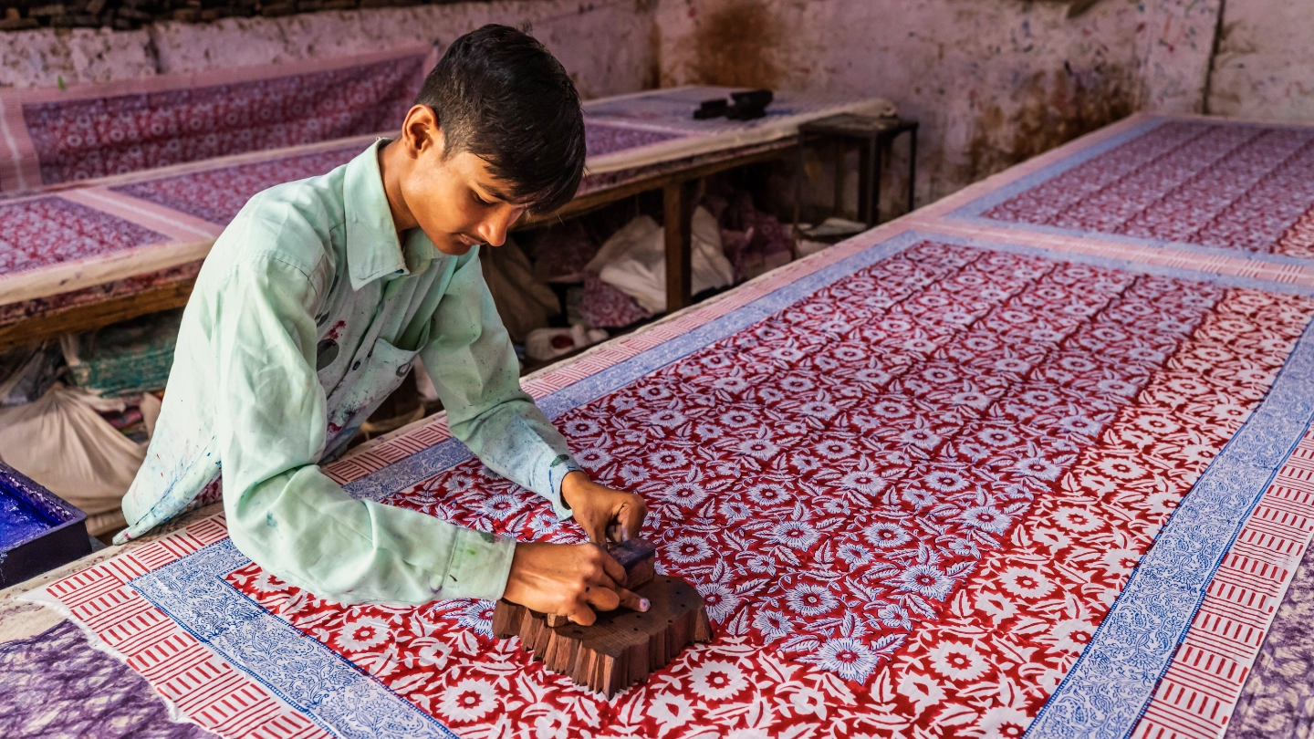 man block printing colourful fabric