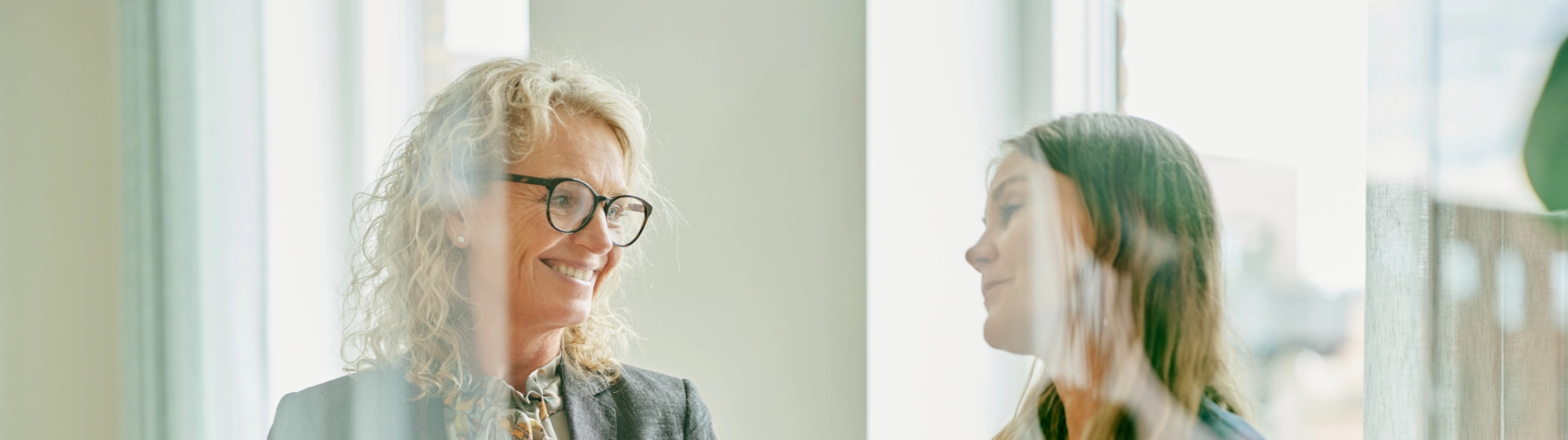 Atradius Danish colleagues talking in the office